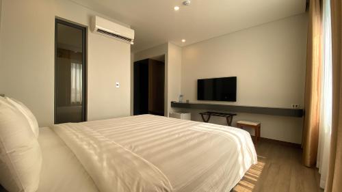 Postel nebo postele na pokoji v ubytování Uông Bí Boutique Hotel