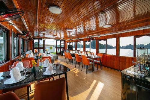 a dining car of a train with tables and chairs at Halong Fantasea Cruise in Ha Long