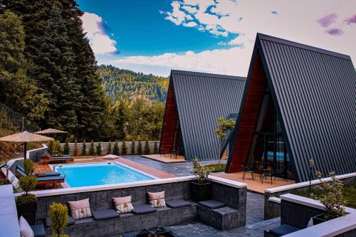 a swimming pool in the middle of a house at Pavliani4rest - Luxury Cabins in Pávliani