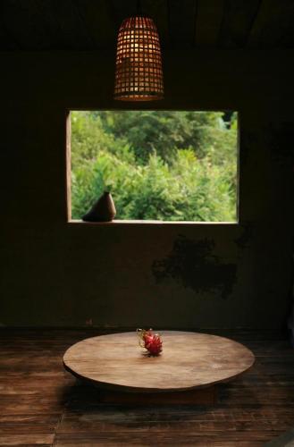 a table with a strawberry on it in front of a window at Sa Moc - La Maison House & Bungalow in Sa Pa
