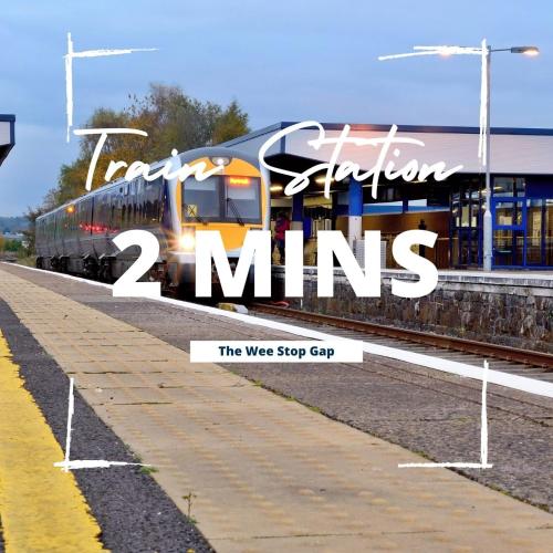 a train on the tracks with the words train extra station mins at 3 Bedroom Apartment, Ballymena, The Wee Stop Gap in Ballymena