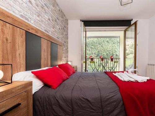 a bedroom with a large bed with red pillows at Increibles Vistas Al Valle De Arinsal NY - A Pie De Pistas - Parking Incluido in Arinsal