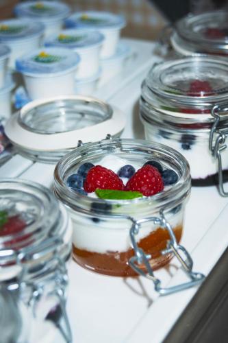 a dessert in a jar with berries on top of it at Aqua Hotel in Děčín