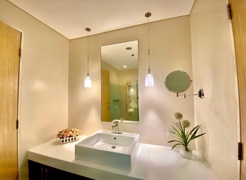 a bathroom with a sink and a mirror at Pico De Loro 2BR Carola B Unit with Lagoon View in Nasugbu
