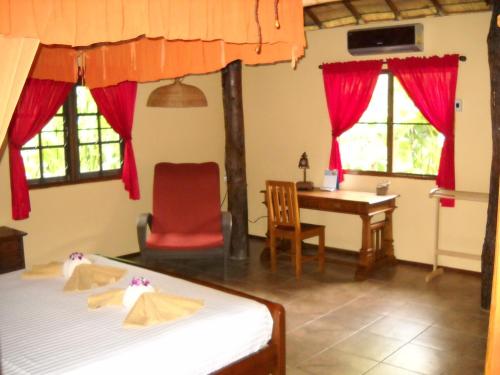 a bedroom with a desk and a bed and a table at Cliffside Lagoon Villa in Ao Nang Beach