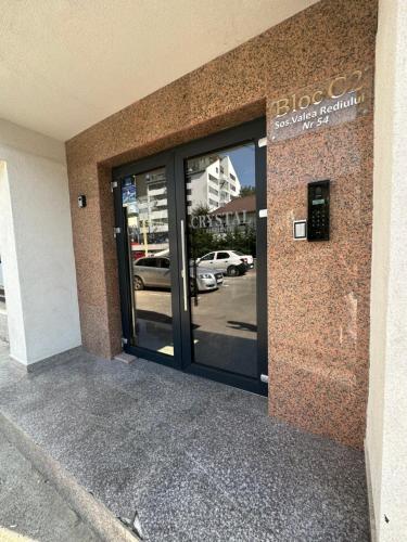 an entrance to a building with glass doors at Complex Rediu 54 Luxury Apartaments in Iaşi