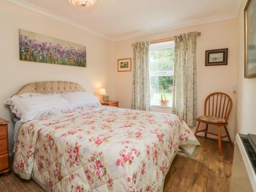 a bedroom with a bed and a window at Little Claremont in Yelverton