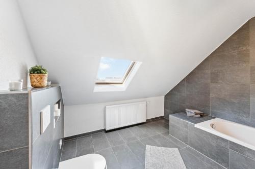 a bathroom with a sink and a bath tub at Casa Bergstraße 3 in Bensheim