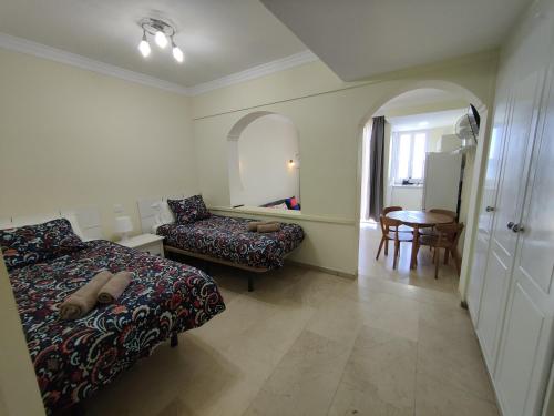 a bedroom with a bed and a chair and a table at Los Nidos in San Bartolomé