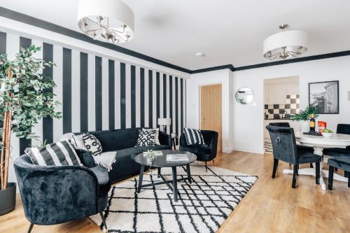 a living room with a couch and a table at Stylish 1 Bed Flat Zone 2 Hampstead Swiss Cottage in London
