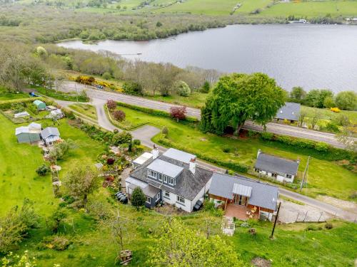 an aerial view of a house and a lake at Urquhart Bay B&B in Drumnadrochit