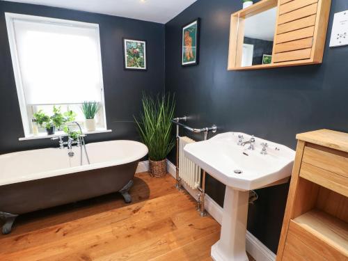 a bathroom with a tub and a sink at Chapel Cottage in Barnard Castle