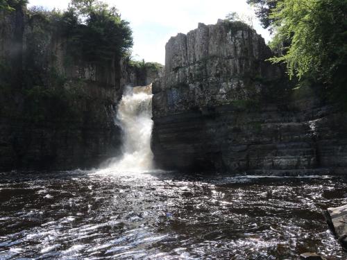 a waterfall in the middle of a river at Chapel Cottage in Barnard Castle