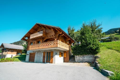 a large wooden house with a gambrel roof at Chalet Muverant - Chatel Reservation in Châtel