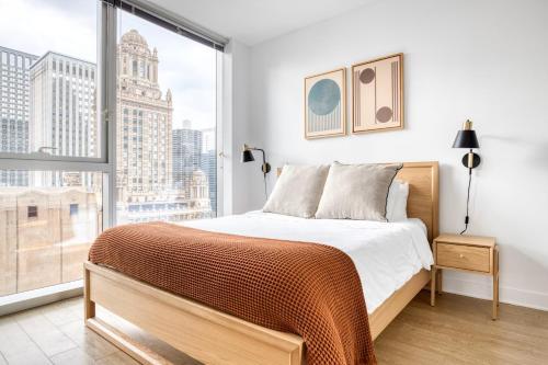 a bedroom with a bed and a large window at Loop 2br w lounge gym nr Chicago Riverwalk CHI-959 in Chicago