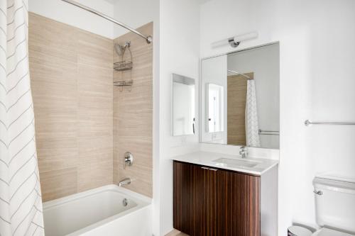 a bathroom with a sink and a tub and a toilet at Loop 2br w lounge gym nr Chicago Riverwalk CHI-959 in Chicago