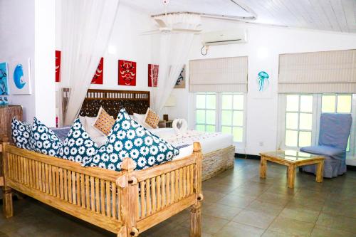 a bedroom with two beds with blue and white pillows at Esperanza Beach Mawella in Tangalle