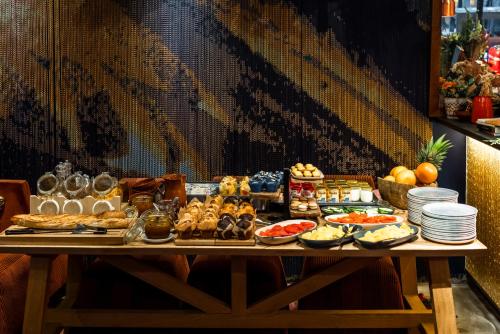 a table with a buffet of food on it at 1K Paris in Paris