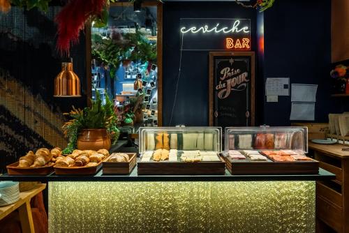 a bakery counter with bread and pastries on it at 1K Paris in Paris