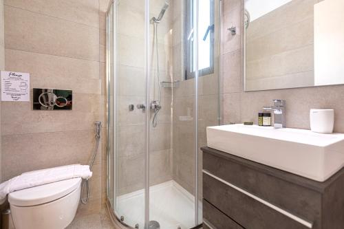 a bathroom with a shower and a sink and a toilet at Phaedrus Living: Luxury Penthouse Potamianou in Athens