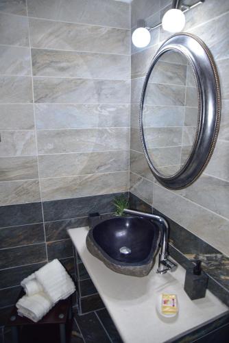 a bathroom with a black sink and a mirror at Elen's Suites Pramanta in Pramanta