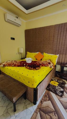 a bedroom with a large bed with a yellow comforter at Dodoma Siesta Inn in Dodoma