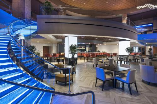 a spiral staircase in a restaurant with tables and chairs at Talking Stick Resort in Scottsdale