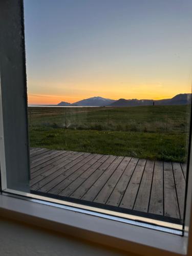 a window view of a view of a field from a house at Vatnsholt in Snæfellsnes - Birta Rentals in Snæfellsbær