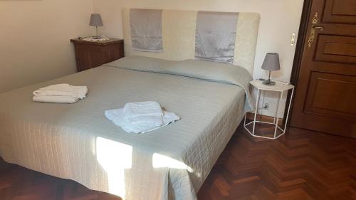a bedroom with a bed with two towels on it at Ai Giardini di San Vitale in Ravenna