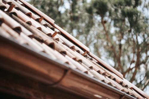 a close up of a wooden roof with trees in the background at Ansitz Layshof Apartment Turm in Merano
