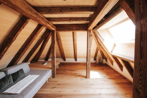 a attic room with a bed and a window at Ansitz Layshof Apartment Turm in Merano