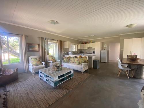 a living room with a couch and a table at Out Of Nature Country Lodge in Windhoek