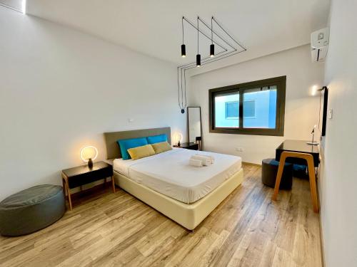 a bedroom with a large bed and a desk at Top Artistic Luxury Apartment in Limassol