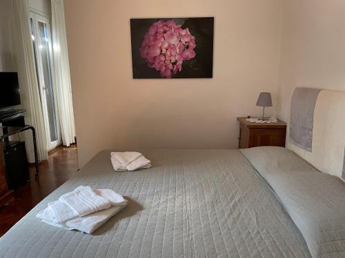 a bedroom with a bed with two towels on it at Ai Giardini di San Vitale in Ravenna