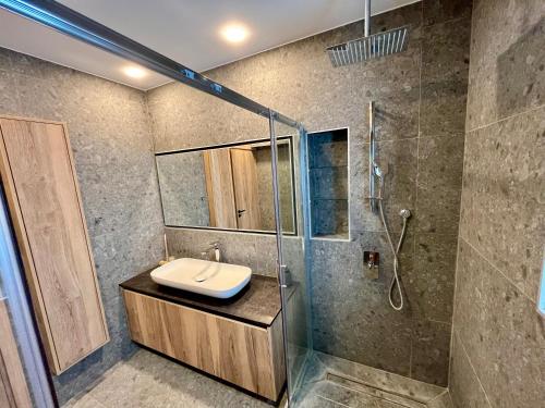 a bathroom with a sink and a shower at Top Artistic Luxury Apartment in Limassol