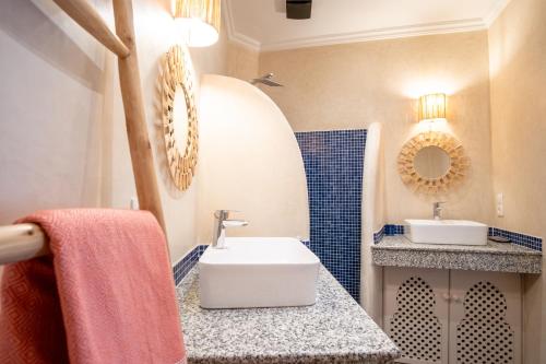 a bathroom with a sink and a mirror at Riad Bibazia in Marrakech
