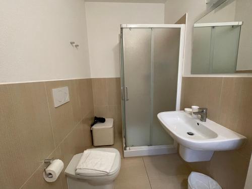 a bathroom with a shower and a sink and a toilet at Ai Giardini di San Vitale in Ravenna