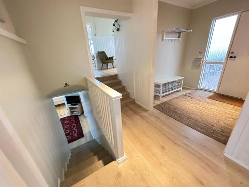 an empty living room with stairs and a hallway at Modern and spacious Holiday Home with Hot Tub in Snæfellsbær