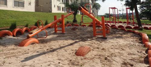 a playground with orange pipes in the sand at Khael Glory home offers 247 security in Kampala