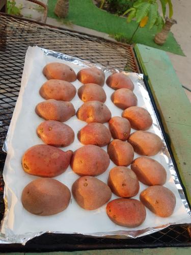 a bunch of food sitting on top of a grill at Bloom Garden Bed & Breakfast in Siem Reap