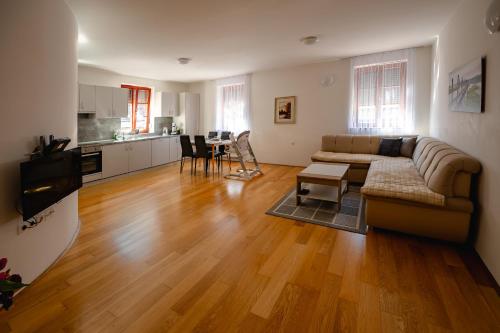 a living room with a couch and a table at Apartmaji Pr' Kopavank in Rateče