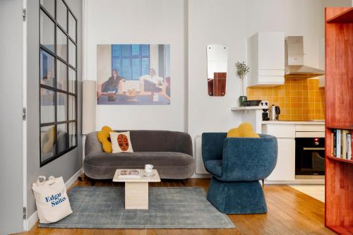 a living room with two chairs and a couch at Balyam Suites Montorgueil - Sentier in Paris