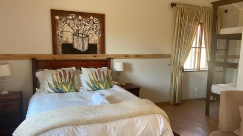 a bedroom with a bed with white sheets at Out Of Nature Country Lodge in Windhoek
