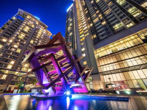 a purple sculpture in front of some tall buildings at Lovely 3-bedrooms with Karaoke Genting Penthouse in Genting Highlands