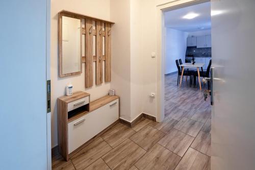 a room with a kitchen and a dining room with a table at Apartmaji Pr' Kopavank in Rateče