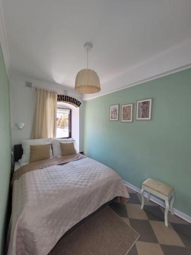 a bedroom with a large bed and a window at Rynek 31 in Lubomierz