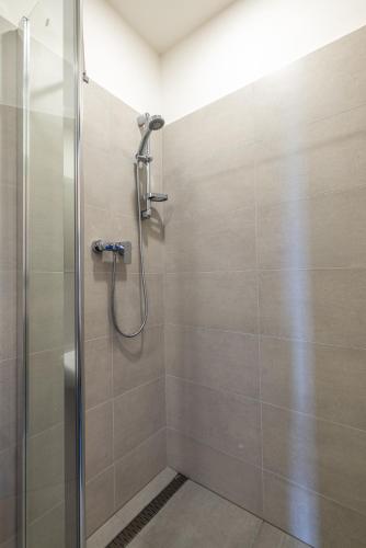 a bathroom with a shower with a glass door at Hotel a ubytovna Zimní stadion Slaný in Slaný