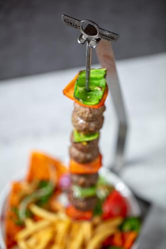 a plate of food with a pair of scissors on top at The Abdali Boulevard Hotel in Amman