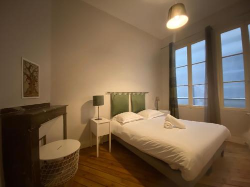 een slaapkamer met een bed, een bureau en een raam bij L'Hypercentre - Au coeur de la vie Toulousaine in Toulouse