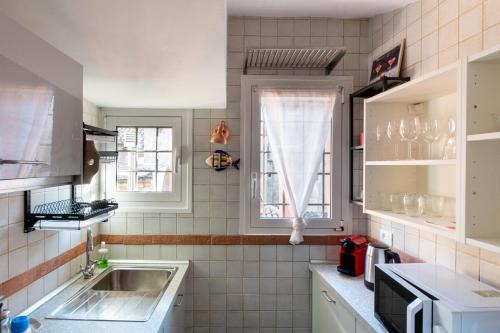 a small kitchen with a sink and a window at HouSmart Tovaglie 9 int. 6 in Bologna